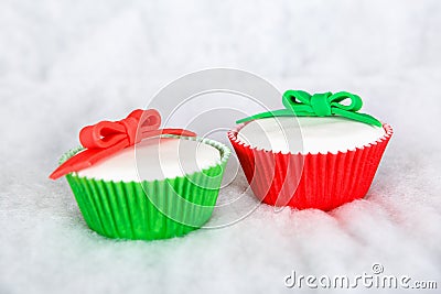 Different Christmas cupcakes on white snow background