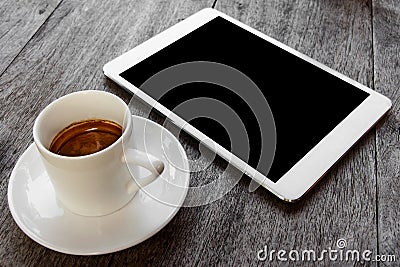 Digital white tablet and coffee cup