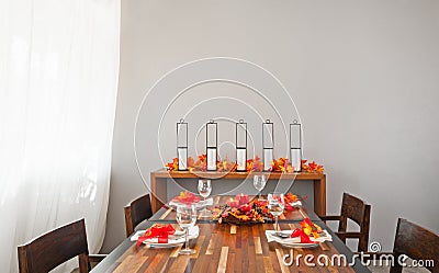 Dinner table setting in warm orange red colors