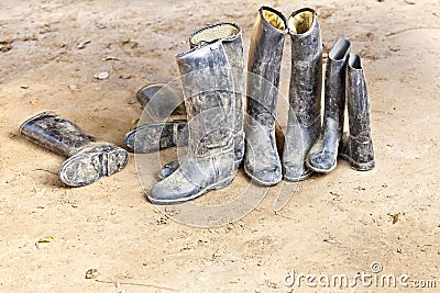 Dirty riding boots standing at muddy ground
