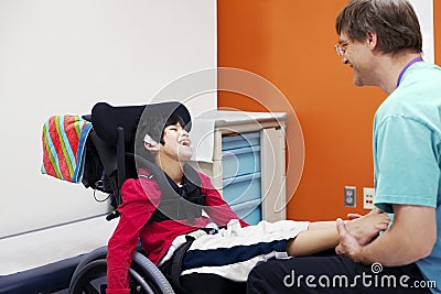Disabled boy in wheelchair with doctor
