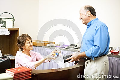 Disabled Clerk Serves Customer