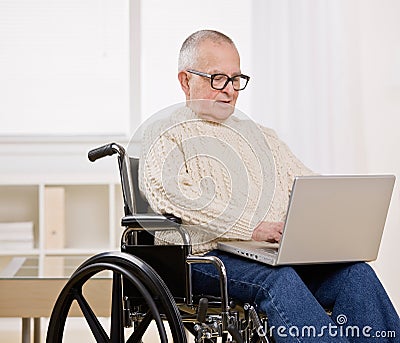 Disabled man in wheelchair on laptop