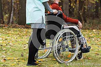 Disabled and nurse on a walk