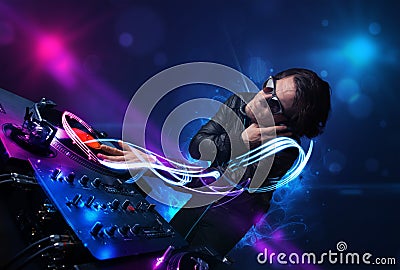 Disc jockey playing music with electro light effects and lights