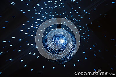 Disco ball, blue light in night club. Indoor