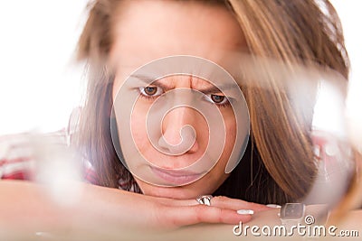 Dissatisfied student looking through a glass lens of the glasses