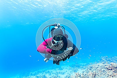 Diver swimming under water
