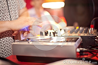 DJ with hands on the turntable