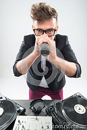 DJ in tuxedo holding microphone and headphones