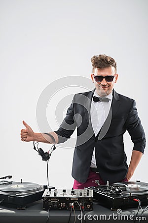 DJ in tuxedo showing his thumb up standing by
