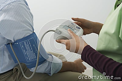 Doctor Checking Patient s Blood Pressure