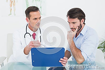 Doctor discussing reports with patient at medical office