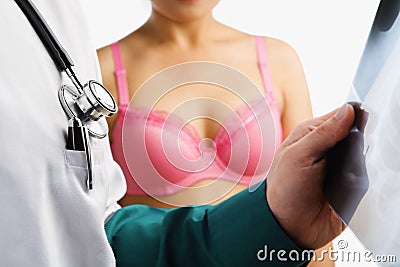 Doctor examine xray slide with woman waiting