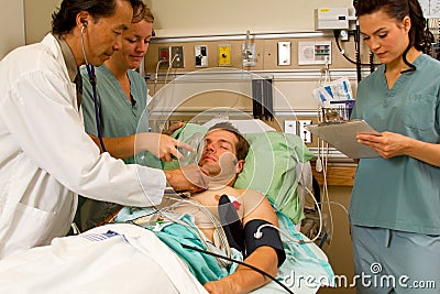 Doctor examing patient, nurse applying oxygen