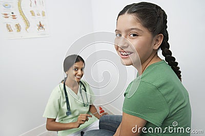 Doctor Examining Girl With Reflex Hammer