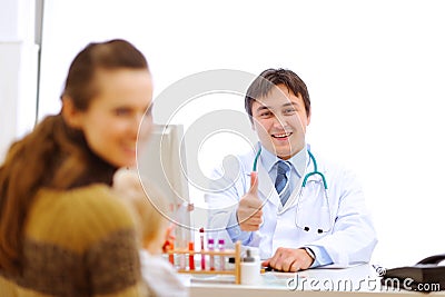 Doctor having consultation with mother with baby
