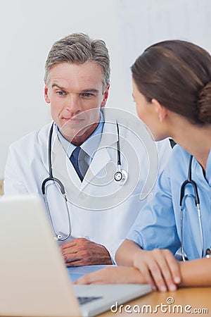 Doctor listening to a colleague