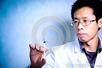 Doctor with medical syringe in hand