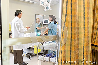 Doctor And Nurses Treating Patient