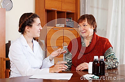 Doctor prescribing medication to woman