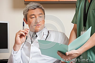 Doctor Reading Patient s File