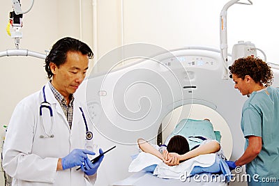 Doctor reviewing chart in x-ray room