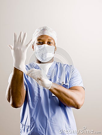 Doctor in scrubs, surgical mask, surgical cap