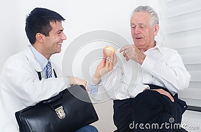 Doctor showing apple to patient