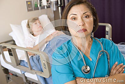 Doctor Standing With Arms Crossed In Patients Room