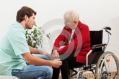 Doctor talking with disabled patient