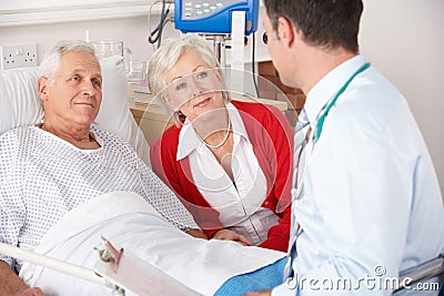 Doctor talking to couple on UK Hospital