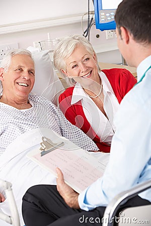 Doctor talking to senior couple in UK Hospital