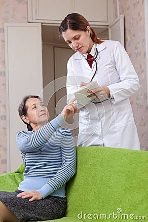 Doctor talks with sick mature patient