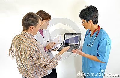 Doctor using computer and reviewing medical report
