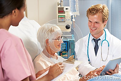 Doctor Using Digital Tablet In Consultation With Senior Patient