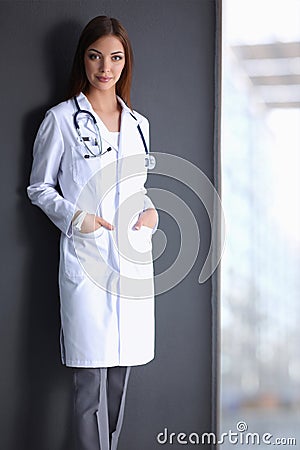 Doctor woman with stethoscope isolated on grey