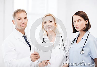 Doctors looking at tablet pc