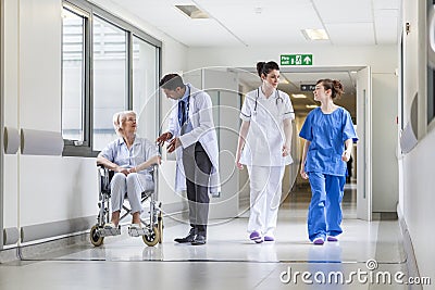 Doctors Nurse senior Female Patient in Hospital Corridor