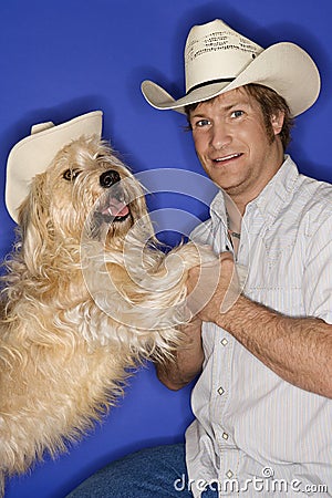 Dog and man wearing cowboy hat