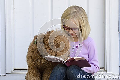 Dog reading with young girl