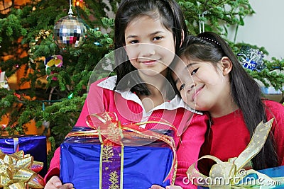 Dos niñas con los regalos de Navidad.