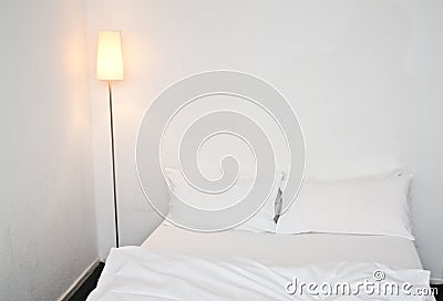 Double bed in white bedroom