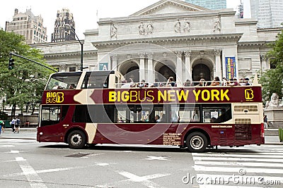 Double-decker tour bus in front of the New York City Library