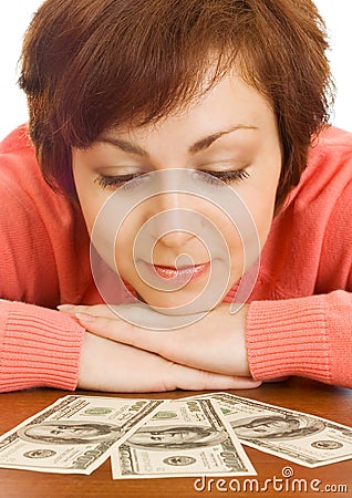 Doubting young woman with money isolated