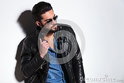 Dramatic fashion model pulling his collar