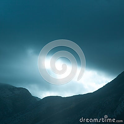 Dramatic rays of light pushing up through clouds