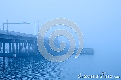 Draw bridge disappearing into heavy fog