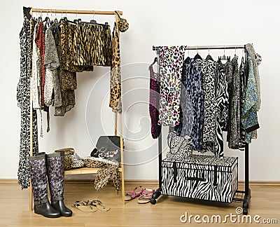 Dressing closet with animal print clothes arranged on hangers.