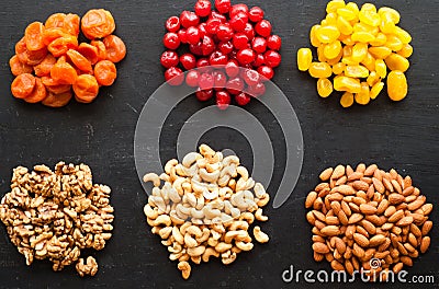 Dried fruits and nuts on black background